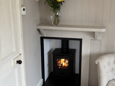 One bed flat, furnished, kitchen, living room with sofabed & woodburner, parking with EV Charger