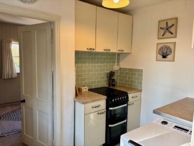 One bed flat, furnished, kitchen, living room with sofabed & woodburner, parking with EV Charger