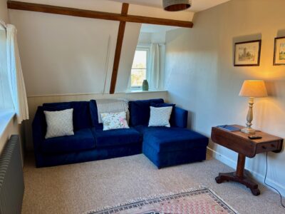 One bed flat, furnished, kitchen, living room with sofabed & woodburner, parking with EV Charger